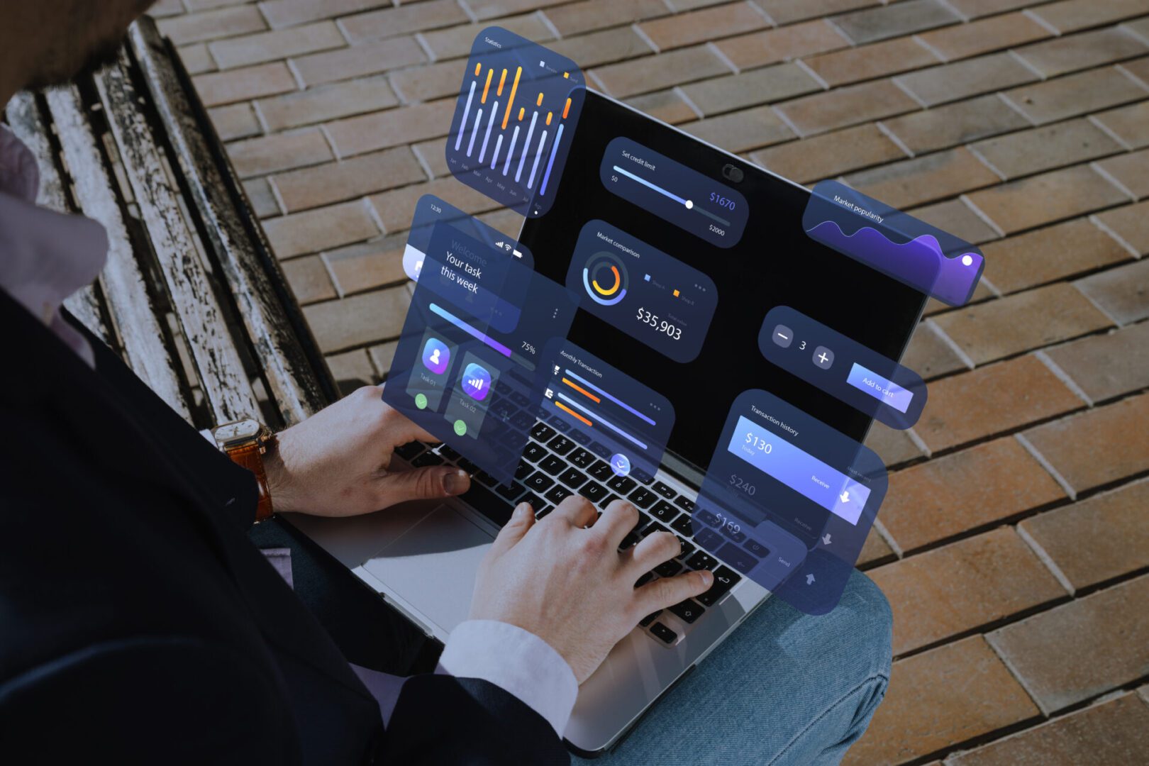 Hands typing on a laptop while seated on an outdoor bench, with semi-transparent holographic UI mock-ups—charts, sliders, task cards, and finance stats—floating above the keyboard to illustrate modern user-experience design and data visualization.