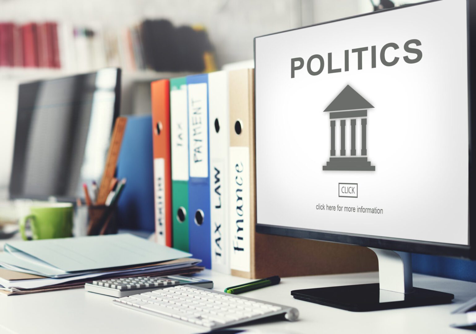 Office workspace with a computer monitor reading ‘POLITICS’ above a courthouse icon and a ‘CLICK’ button, next to colorful ring binders labeled ‘TAX,’ ‘LAW,’ ‘FINANCE,’ and ‘PAYMENT’ on a tidy desk with keyboard, calculator, and papers.